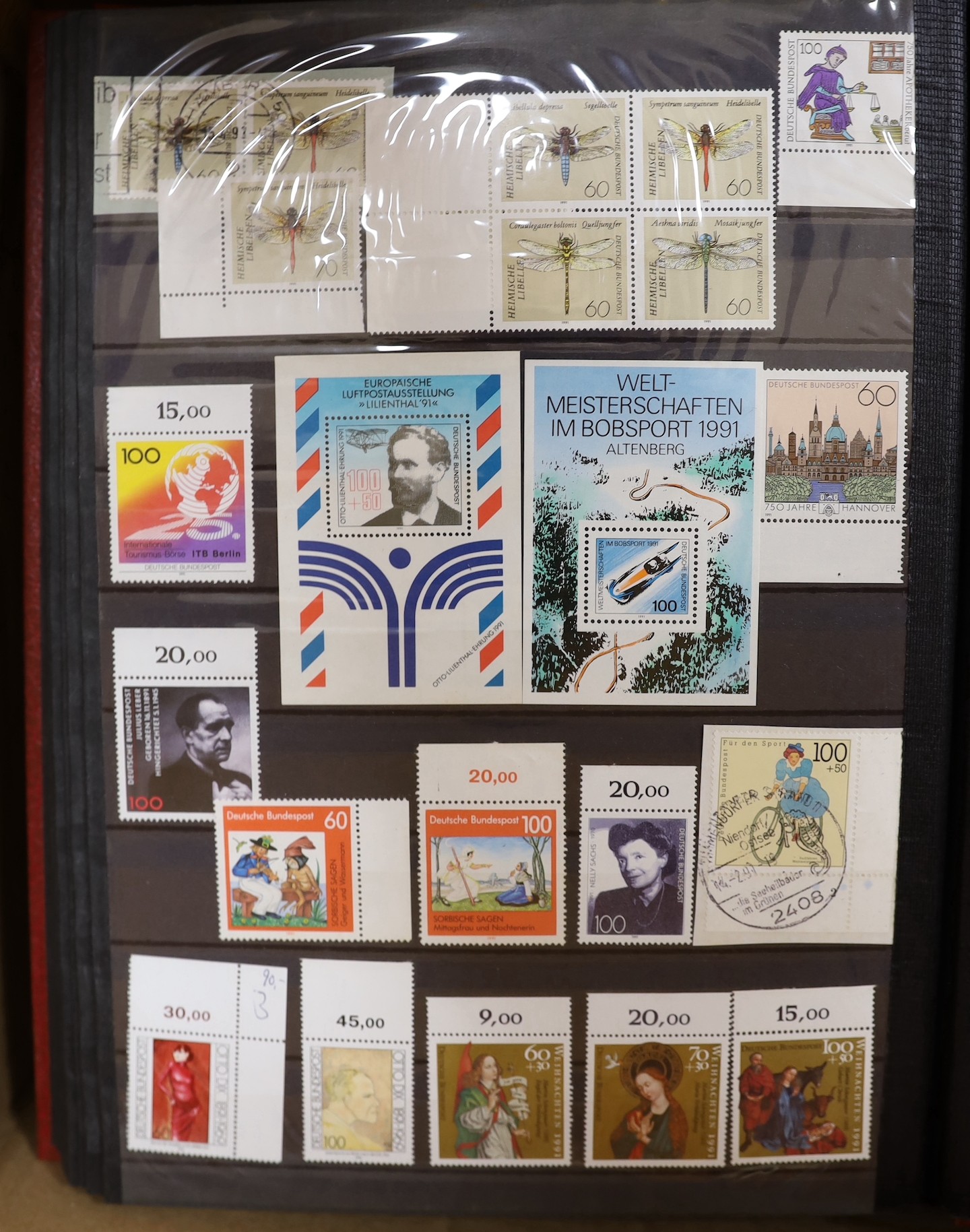 Four stock books of British stamps, QEII mint unused definitives and stamp books, some pre-decimal and two stock books of DDR used and mint unused stamps